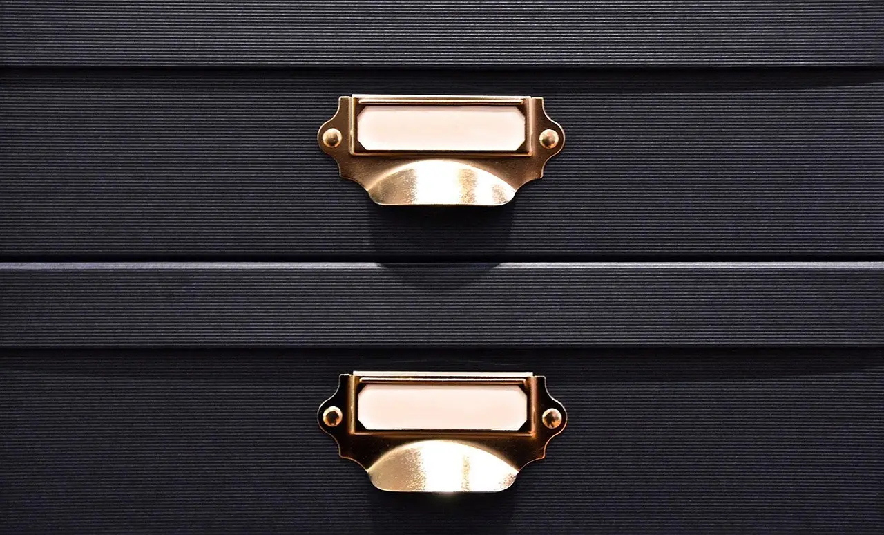 A set of closed drawers in a filing cabinet
