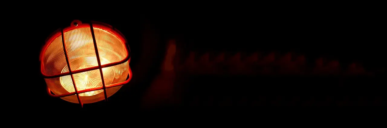 An amber warning light glowing in the dark