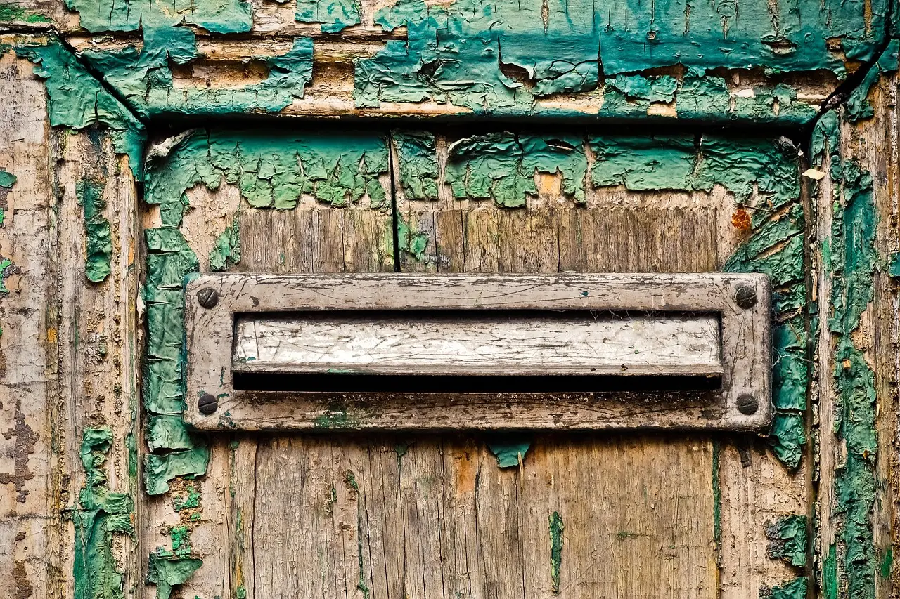 A letterbox slot in a painted door